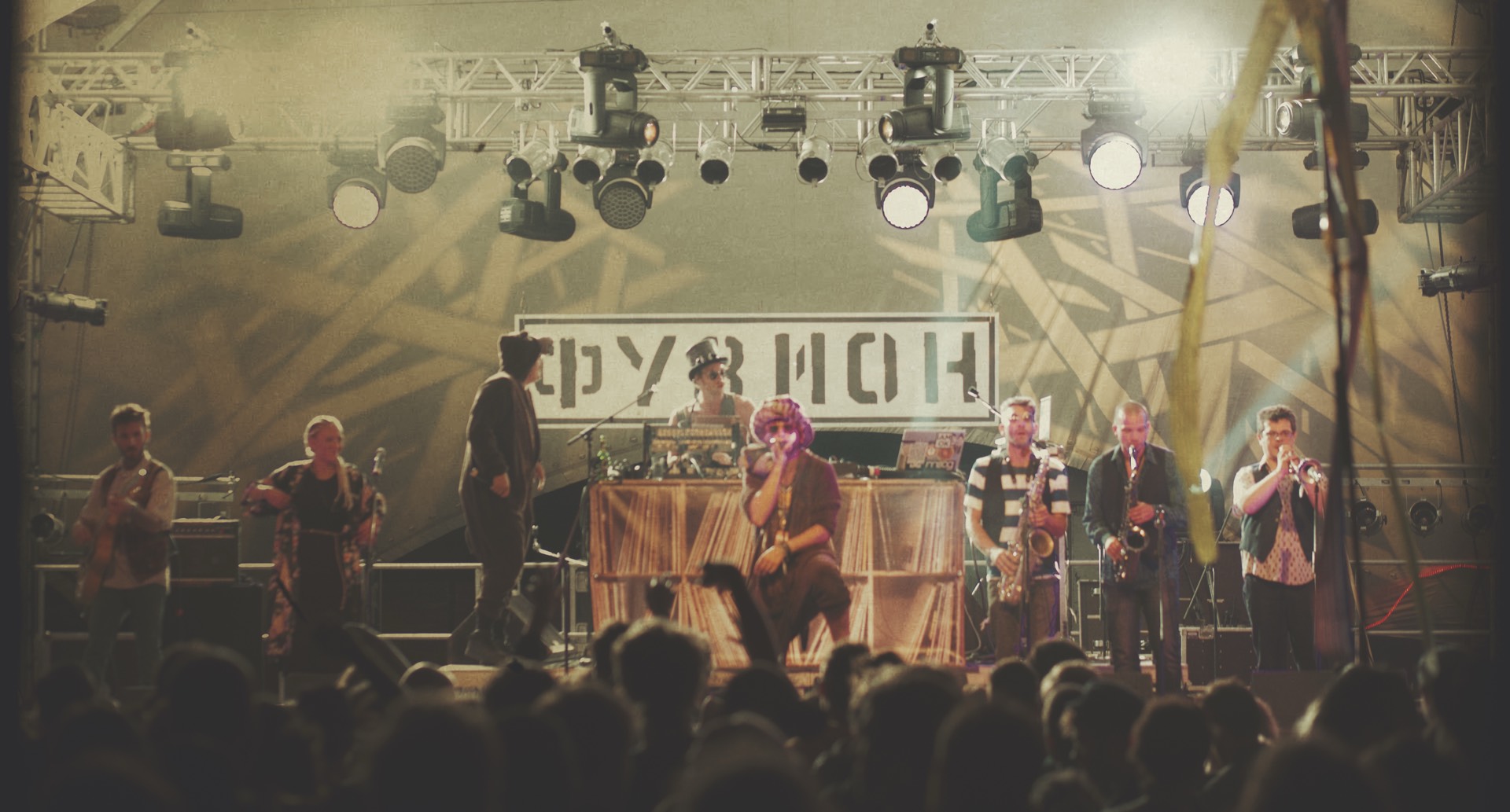 The full nine-piece line-up performing on a festival stage at night